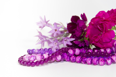 feminine and romantic pearls and flowers in violet toneの写真素材