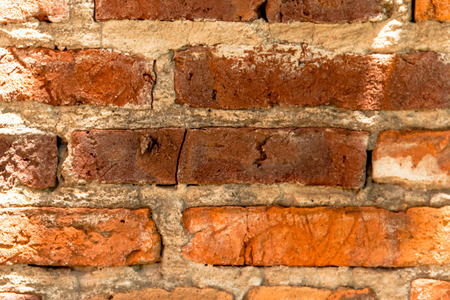 background of uneven old bricks with shadows