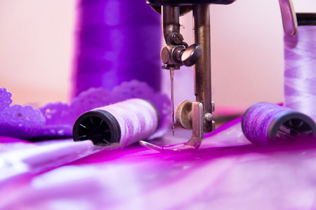 antique sewing machine and sewing elements in violet tonesの写真素材