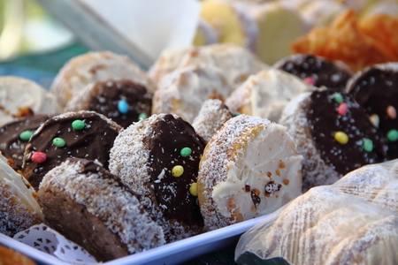 alfajores fried cakes and churros for sale at the street fair