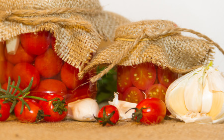 pickled cherry tomatoes in vinegar with garlic and spicesの写真素材