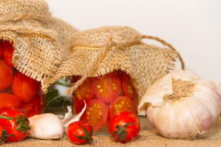 pickled cherry tomatoes in vinegar with garlic and spicesの写真素材