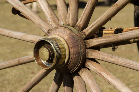 old wooden wheel and sulky bronze in the fieldの写真素材