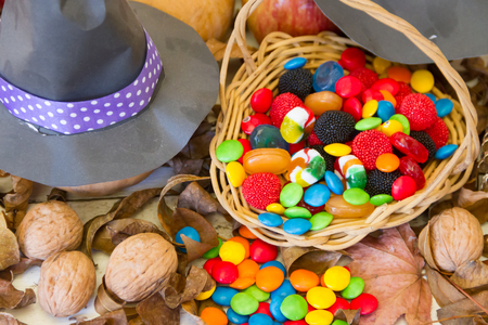 Basket with Halloween candy and autumn decorationsの写真素材
