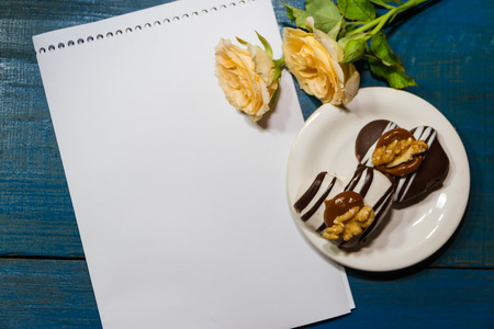 romantic coffee background with sweet cookies and roses with salutationsの写真素材