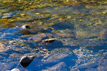 water texture background running over the stonesの写真素材