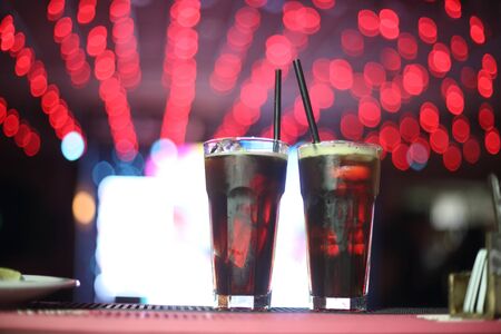 Assorted drinks of orange fernet lemon in the pub with the backlightsの写真素材