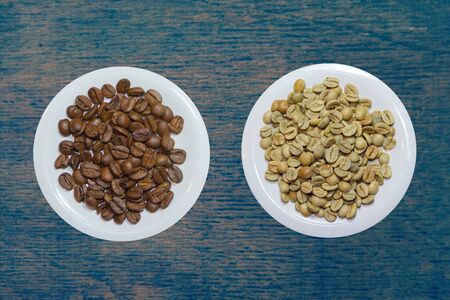 top view variety of roasted and green coffee beans on rustic backgroundの写真素材