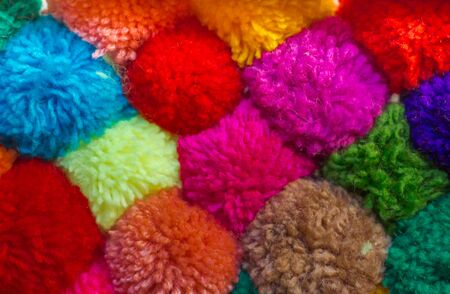 textured background of assorted and multicolored wool pom pomsの写真素材
