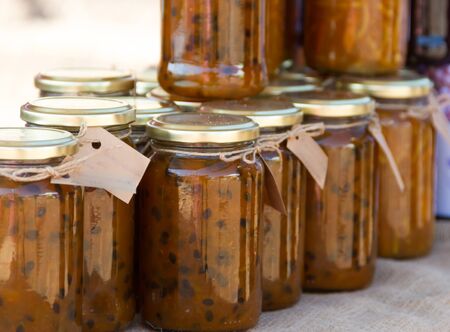 jars with passion fruit jams at the street fairの写真素材