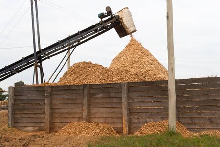 hopper forming a pile of sawdust in the wood industryの写真素材