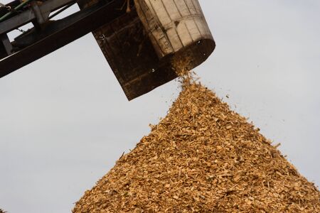 hopper forming a pile of sawdust in the wood industryの写真素材