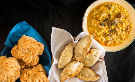 dishes of locro empanadas and sweet pastries, traditional Argentine foods that are frequently consumed for national holidays, such as the revolution of May 25 and independence on July 9の写真素材