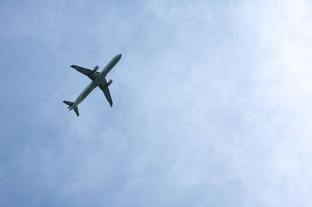 the plane is flying in the skyの写真素材