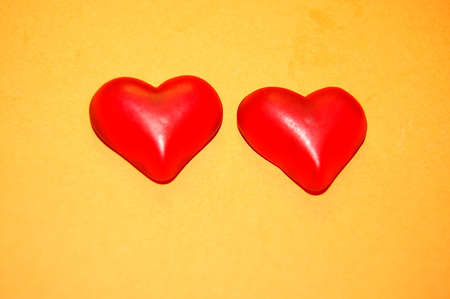 the two hearts on yellow backgroundの写真素材