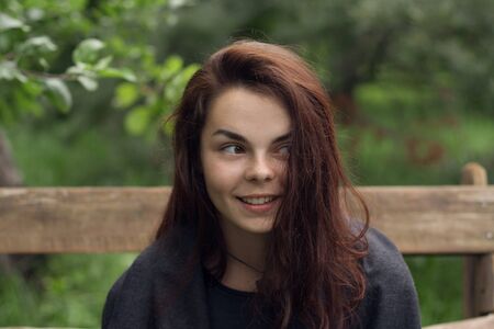 Young girl with a beautiful smile in the parkの写真素材