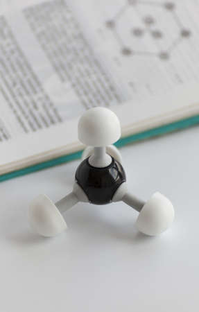 methane molecule next to the chemistry bookの写真素材