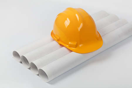 hardhat on construction blueprint rolls