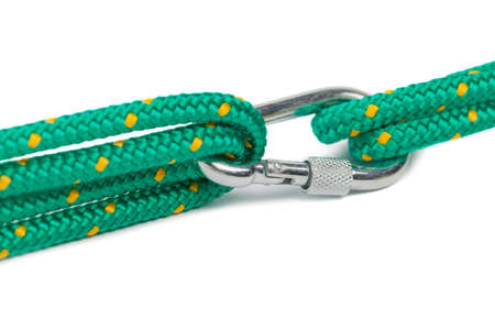 Macro shot of carabiner with rope on blank background