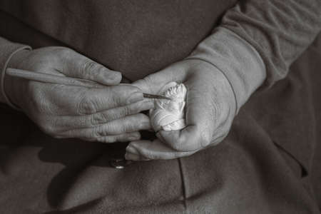 Talented artisan carving a meerschaum stone with a scalpel in his workshopの写真素材