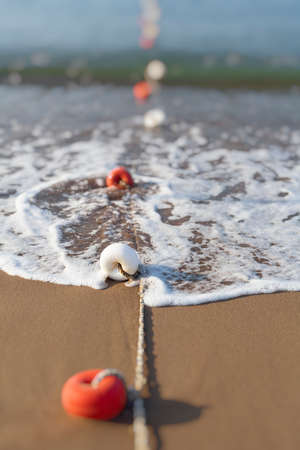 Close-up photograph of floats at the beach
