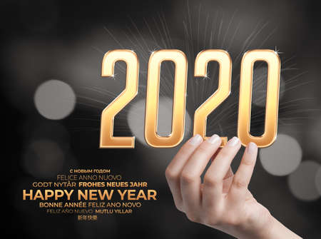 Female hand holding  2020 text and below it happy new year message in english, german, italian,...