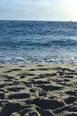 View from the sand to the blue sea during the winter seasonの写真素材