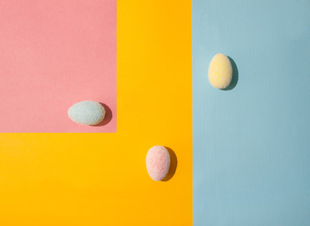 colorful easter eggs on a yellow blue pink decorative creative background.の写真素材