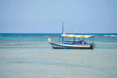 Boat on the beach at Morro de Sao Paulo, Brazilの写真素材
