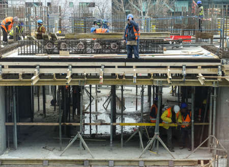 Bucharest, Romania, 17  February 2016: Laborers work at the construction site of a building in Bucharest.のeditorial素材