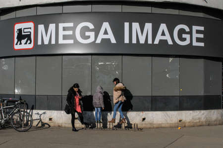 Bucharest, Romania, 7 February 2016: A group of women are seeing in front of a Mega Image supermarket in Bucharest.のeditorial素材