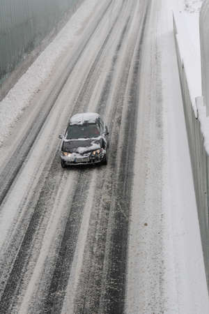 Bucharest, Romania, 17 January 2016: A car is seen on a road, during a snowfall in Bucharest.のeditorial素材