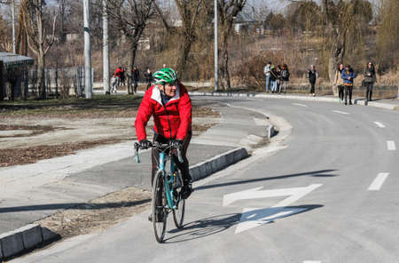 Bucharest, Romania, 7 February 2016: A man is riding a bicycle in a park in Bucharest.のeditorial素材