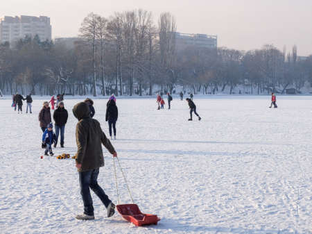 Bucharest, Romania, January 24, 2016: People are skating  on a frozen lake in Bucharest.のeditorial素材