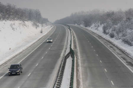 A2 Highway, Romania, January 23, 2016: Cars are passing on the highway A2, the main commercial route which connects Bucharest to the Black Sea's port, Constanta.のeditorial素材