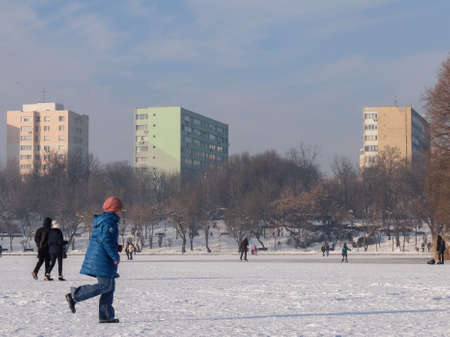 Bucharest, Romania, January 24, 2016: People are walking on a frozen lake in Bucharest.のeditorial素材