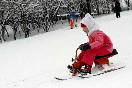 BUCHAREST, ROMANIA - January 07, 2017: Joyful children are sledding down the hills on a winter day, in a central park during the vacation.のeditorial素材