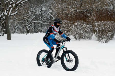 BUCHAREST, ROMANIA - January 07, 2017: Ice Biking on the hills covered with fresh snow in the central park, in a winter day during the vacation.のeditorial素材