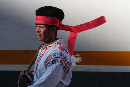 Bucharest, Romania, December 30, 2012: A man dressed in national costumes and wearing a whip is performing in a tram station in Bucharest.のeditorial素材