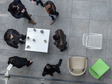 Bucharest, Romania, March 18, 2016: People are smoking and drinking coffee in an outdoor smoking area of an office building in Bucharest.のeditorial素材