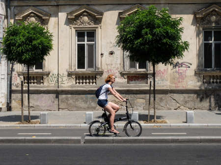 Bucharest, Romania, July 24, 2016: A woman is riding a bicycle on a designed track for bicycles, in the center of  Bucharest.のeditorial素材