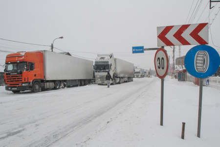 Afumati, Romania, January 26, 2014: Trucks are parked on a closed road in Afumati because of the severe weather conditions.のeditorial素材