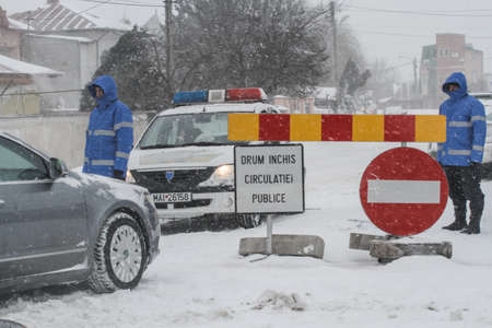 Afumati, Romania, January 26, 2014: Police closed a road in Afumati because of the severe weather conditions.のeditorial素材