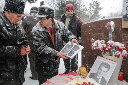 Bucharest, Romania, January 26, 2014: People gathered at the grave of Romania's late communist dictator Nicolae Ceausescu, to commemorate his birthday. Year after year Romania's nostalgic Communists gather to mourn Ceausescu, who was executed on Christmasのeditorial素材