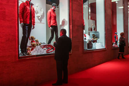 Bucharest, Romania, December 5, 2009: A man is looking at the products displayed in the window of the Ferrari showroom in Bucharest.のeditorial素材