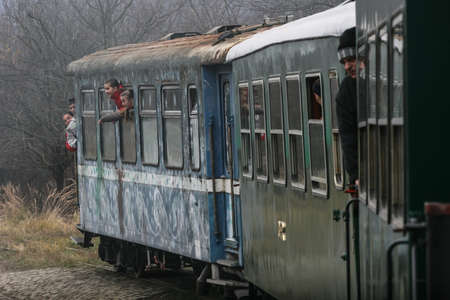 Brad, Romania, December12, 2009: Tourists are travel in an old steamed cog train in Brad, on winter holydays.のeditorial素材