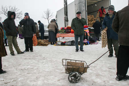 Calugareni, Romania, December 20, 2009: Vendors are selling different products in the animal market in Calugareni. Before Christmas, animal breeders are selling and sacrificing their animals in animal markets and vendors are selling different products.のeditorial素材