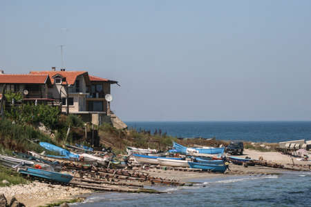 Black Sea, Romania, June 27, 2009: Fishing boats are parked on the coastline near to a hotel.のeditorial素材
