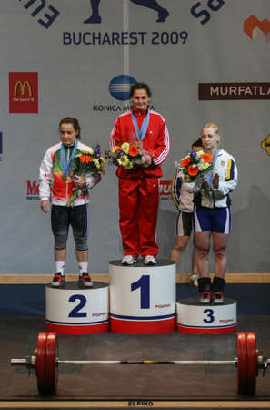 Bucharest, Romania, April 5, 2009: Romela Begaj (Albania), first place, Nastassia Novikava (Bulgaria), second place,  Yuliya Kalina (Ukraine), third place are awarded in the European Weightlifting Competition in Bucharest.のeditorial素材