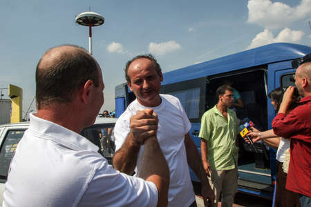 Bucharest, Romania, August 14, 2009: Members of the Italian towboat Buccaneer who were kidnapped by Somali pirates in Aden Gulf on August 9-10, are welcomed by their families and press representatives on the Henri Coanda airport.のeditorial素材